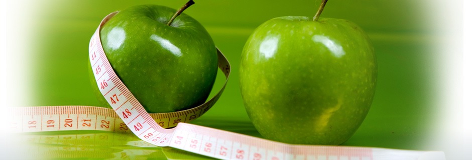 Two green apples with measuring tape