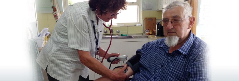 Elderly man having his blood pressure checked